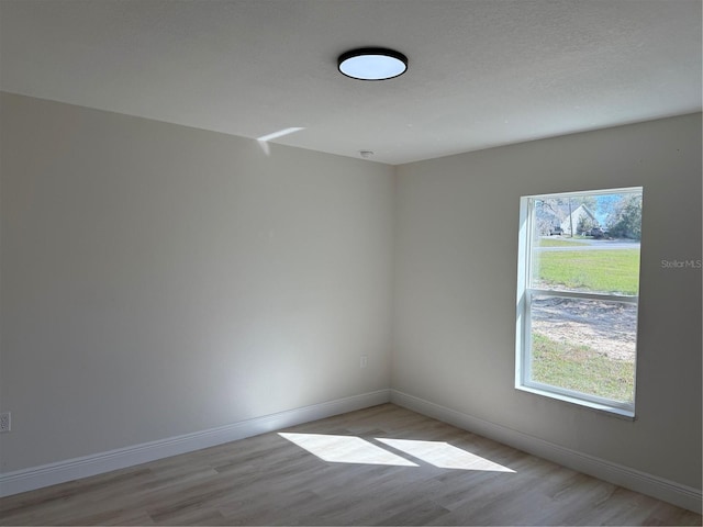 31 Juniper Pass Ln, Ocala, FL 34480 - unfurnished room featuring light wood finished floors, healthy amount of natural light, and baseboards