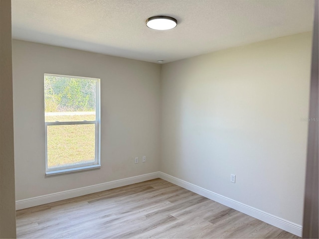 31 Juniper Pass Ln, Ocala, FL 34480 - unfurnished room featuring light wood-type flooring, baseboards, and a textured ceiling