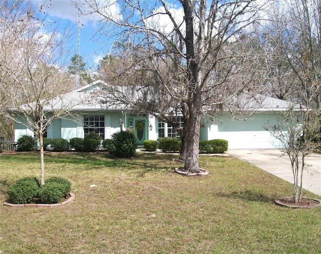 single story home featuring a garage, a front yard, concrete driveway, and stucco siding