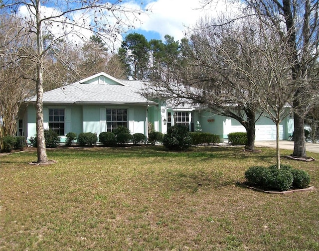 ranch-style home featuring a garage, a front lawn, roof with shingles, and stucco siding