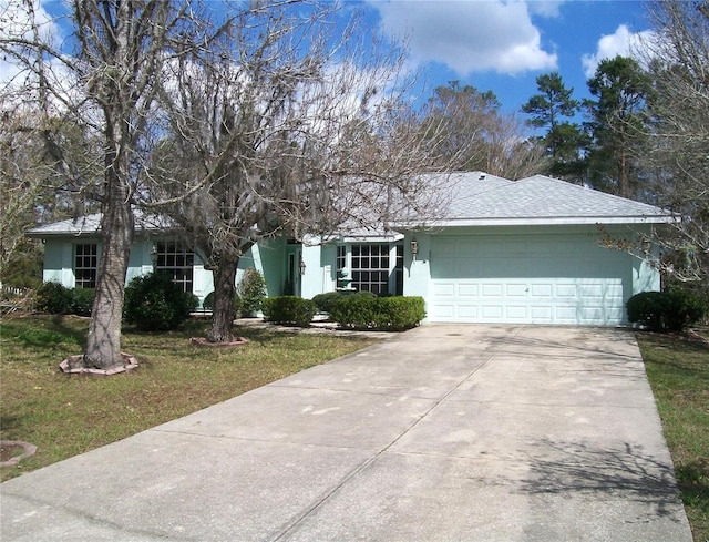 ranch-style house featuring an attached garage, concrete driveway, and stucco siding