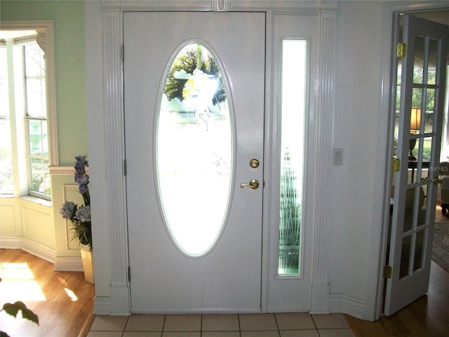 entryway featuring light tile patterned flooring and plenty of natural light