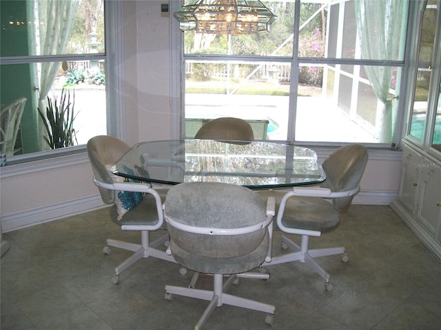 sunroom featuring a chandelier