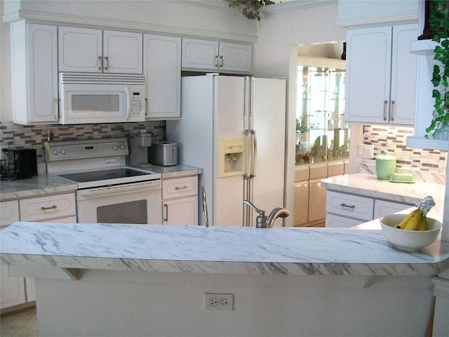 kitchen featuring white appliances and white cabinets