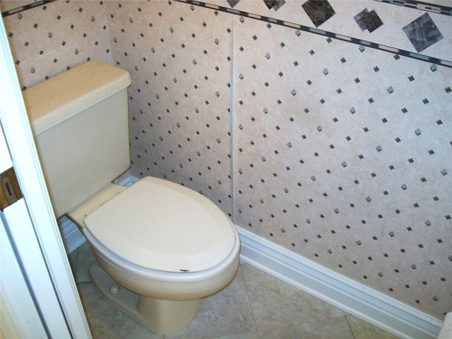 bathroom featuring toilet and tile patterned floors