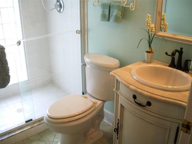 bathroom with tile patterned flooring, a shower stall, toilet, and vanity