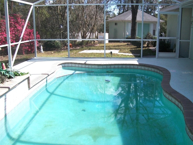 pool featuring a lanai and a patio area