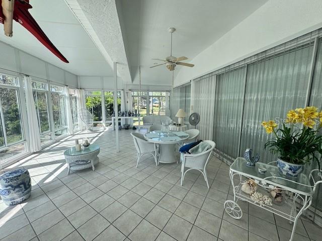 sunroom / solarium featuring vaulted ceiling and ceiling fan