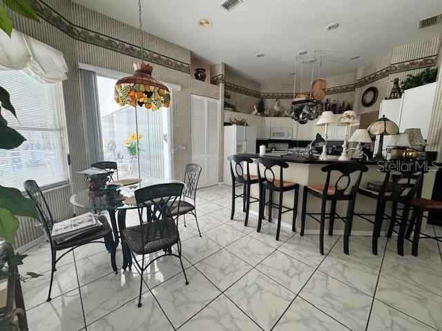 dining room featuring visible vents and marble finish floor