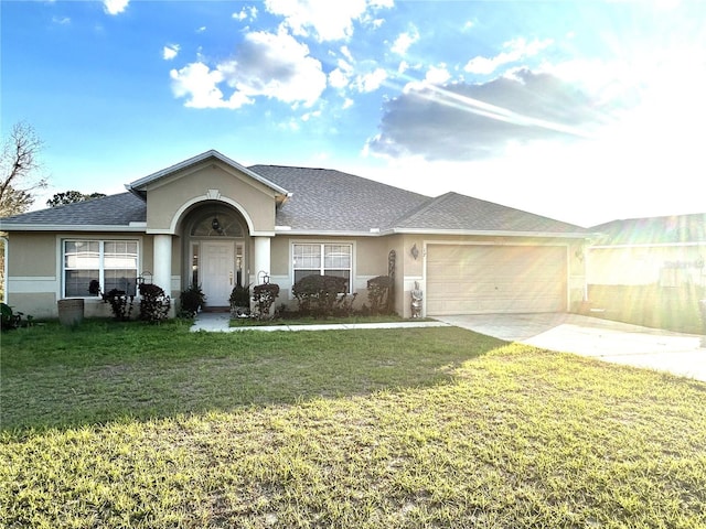 ranch-style home featuring concrete driveway, stucco siding, roof with shingles, an attached garage, and a front yard