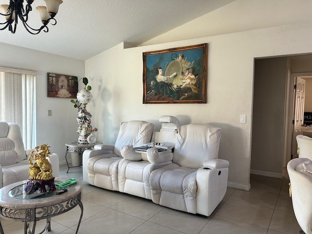 living room with light tile patterned floors, baseboards, an inviting chandelier, vaulted ceiling, and a textured ceiling