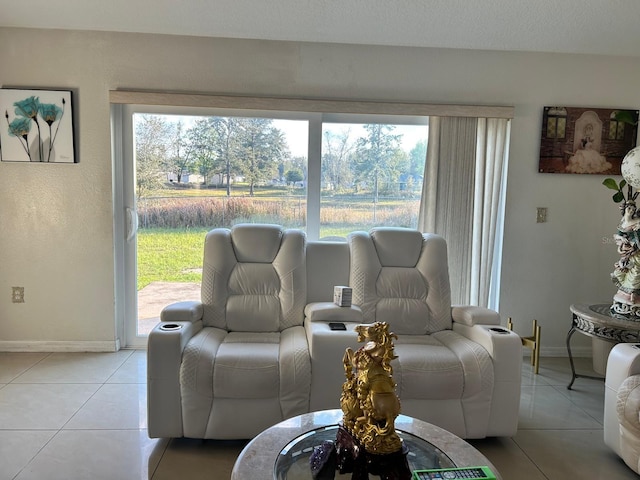 living area featuring light tile patterned floors and baseboards