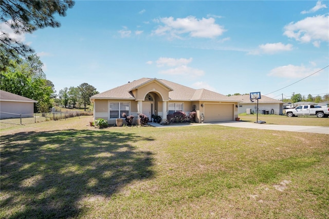 ranch-style house featuring a front yard, concrete driveway, stucco siding, an attached garage, and fence