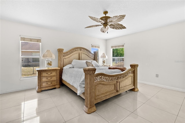 bedroom featuring light tile patterned flooring, ceiling fan, and baseboards