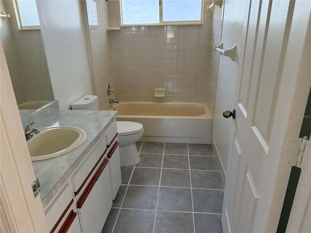 bathroom featuring toilet, shower / bathtub combination, tile patterned flooring, and vanity