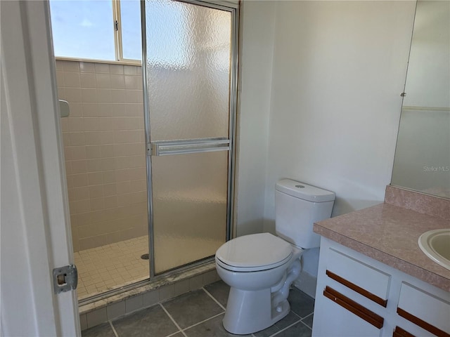 full bathroom with toilet, a stall shower, vanity, and tile patterned floors