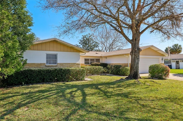 single story home with a garage, a front lawn, and concrete driveway