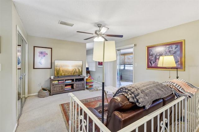 bedroom with baseboards, visible vents, ceiling fan, and light colored carpet