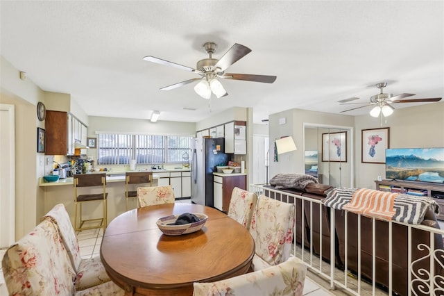 dining space with light tile patterned flooring, ceiling fan, and visible vents