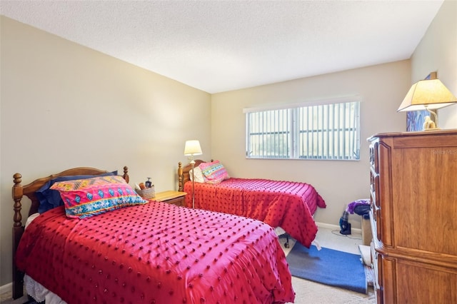 bedroom featuring carpet floors, a textured ceiling, and baseboards