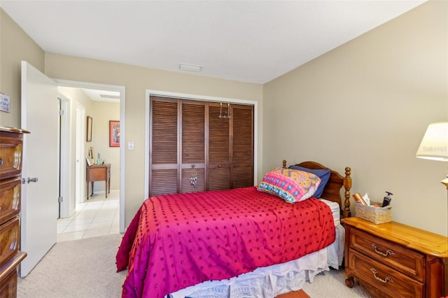 bedroom with light tile patterned floors, a closet, and visible vents