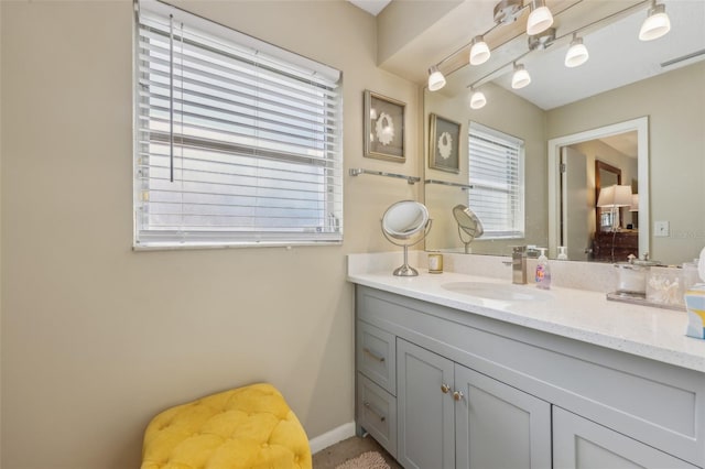 bathroom featuring visible vents, baseboards, and vanity