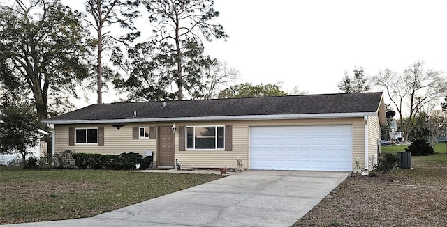 ranch-style house with a garage, a front yard, concrete driveway, and central air condition unit