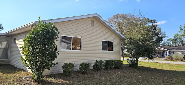 view of side of home featuring a yard