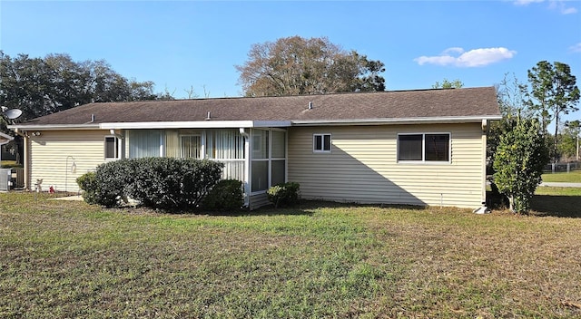 rear view of property featuring a yard