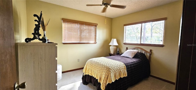 bedroom featuring a textured ceiling, carpet, a ceiling fan, and baseboards