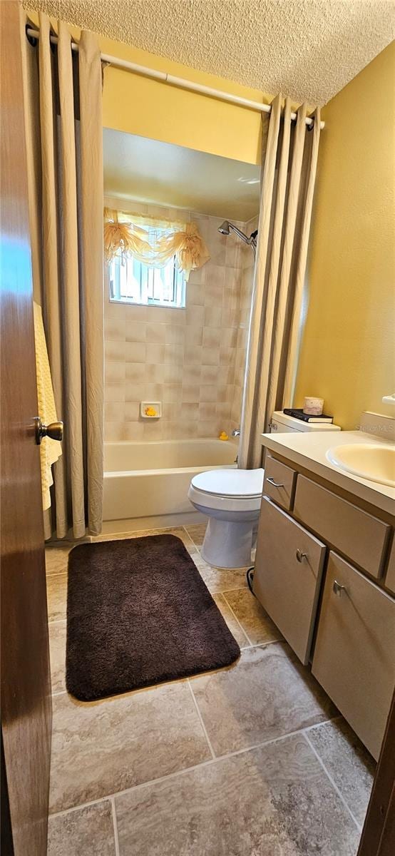 bathroom with toilet, a textured ceiling, shower / tub combo with curtain, and vanity