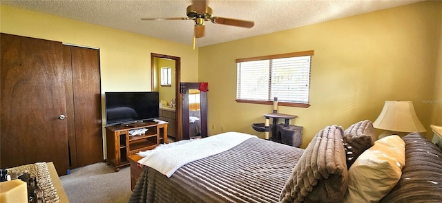 bedroom with a ceiling fan, a closet, light carpet, and a textured ceiling