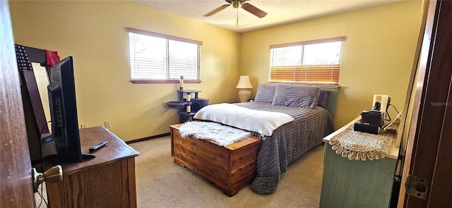 bedroom featuring light colored carpet, multiple windows, a textured ceiling, and baseboards