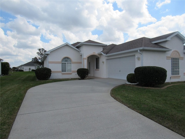 ranch-style house featuring a garage, concrete driveway, a front lawn, and stucco siding