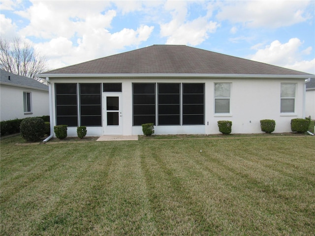 2459 NW 55th Avenue Rd, Ocala, FL 34482 - back of property featuring a sunroom, stucco siding, a lawn, and roof with shingles