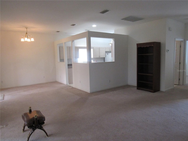 2459 NW 55th Avenue Rd, Ocala, FL 34482 - spare room with a chandelier, light colored carpet, and visible vents