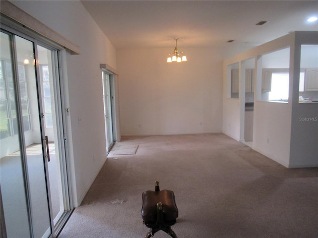 2459 NW 55th Avenue Rd, Ocala, FL 34482 - empty room with light carpet, visible vents, and an inviting chandelier