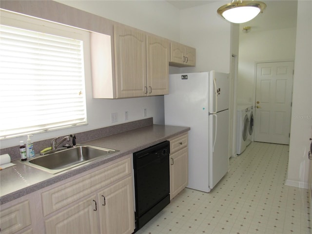 2459 NW 55th Avenue Rd, Ocala, FL 34482 - kitchen with washer / dryer, black dishwasher, freestanding refrigerator, light floors, and a sink