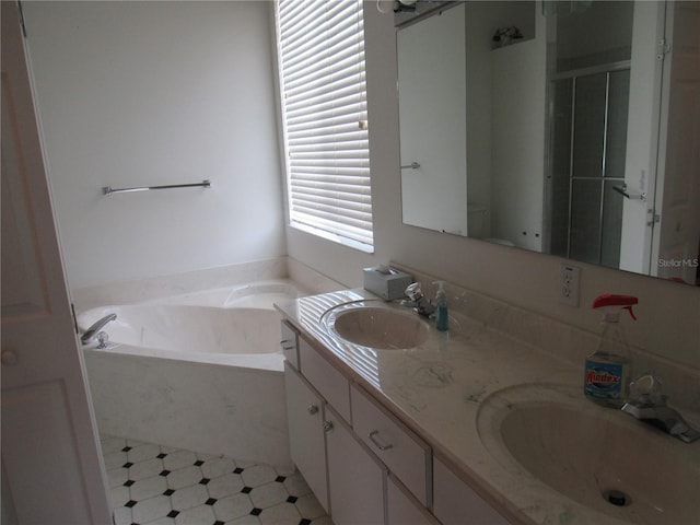 2459 NW 55th Avenue Rd, Ocala, FL 34482 - bathroom featuring a bath, double vanity, a sink, and tile patterned floors