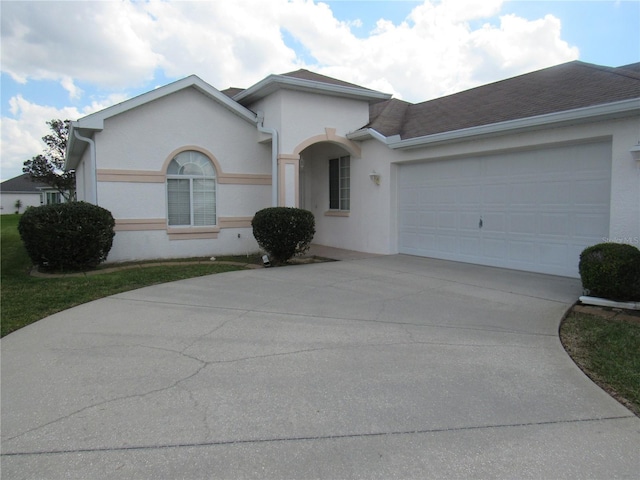 2459 NW 55th Avenue Rd, Ocala, FL 34482 - single story home with a garage, roof with shingles, driveway, and stucco siding