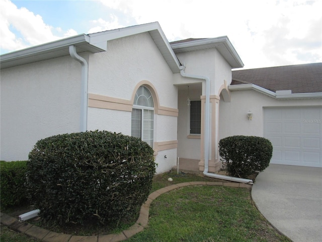 2459 NW 55th Avenue Rd, Ocala, FL 34482 - property entrance with an attached garage and stucco siding