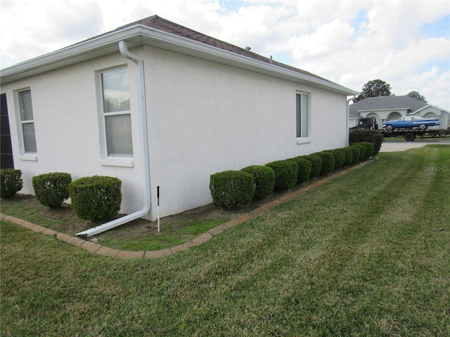 2459 NW 55th Avenue Rd, Ocala, FL 34482 - view of side of property with a yard and stucco siding