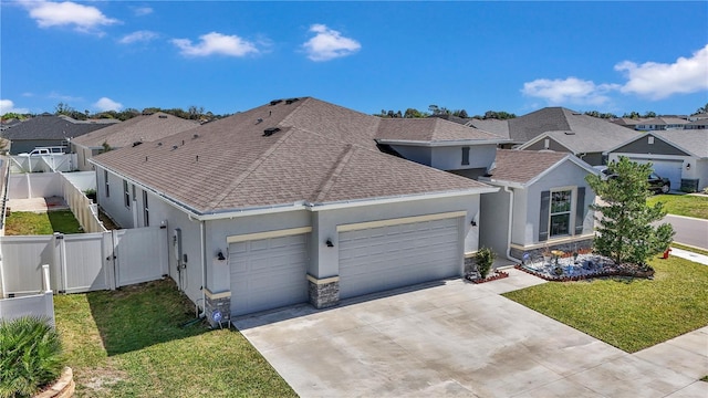 view of front facade featuring a garage, a gate, a residential view, and a front yard