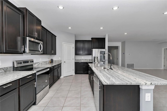 kitchen with visible vents, an island with sink, appliances with stainless steel finishes, a sink, and recessed lighting