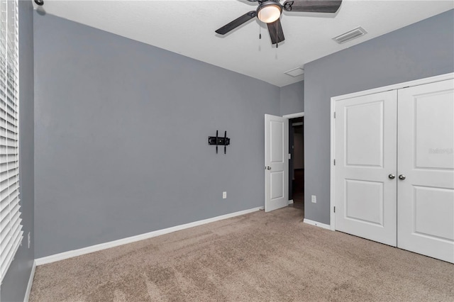 unfurnished bedroom with visible vents, baseboards, ceiling fan, carpet, and a closet