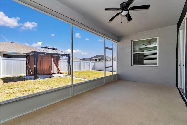 unfurnished sunroom with a ceiling fan