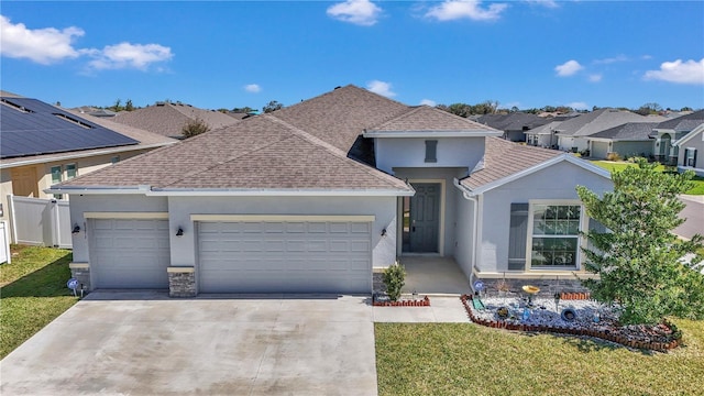 view of front of house featuring a garage, stone siding, and a front yard