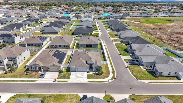 birds eye view of property with a residential view