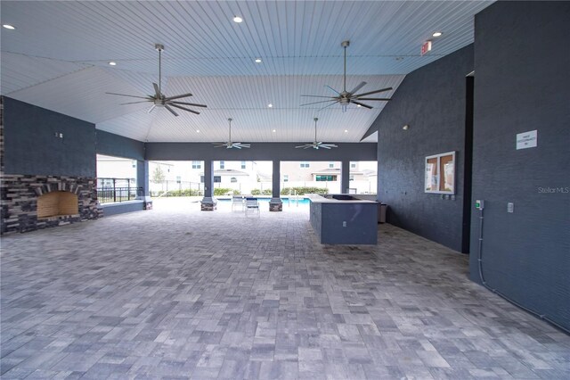 view of patio with an outdoor pool and a ceiling fan