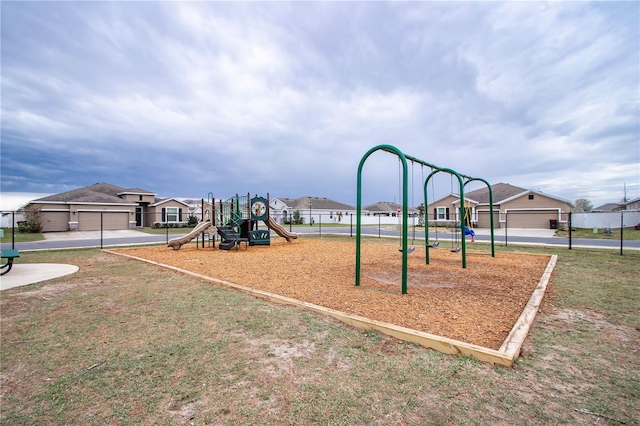 communal playground with a residential view and fence